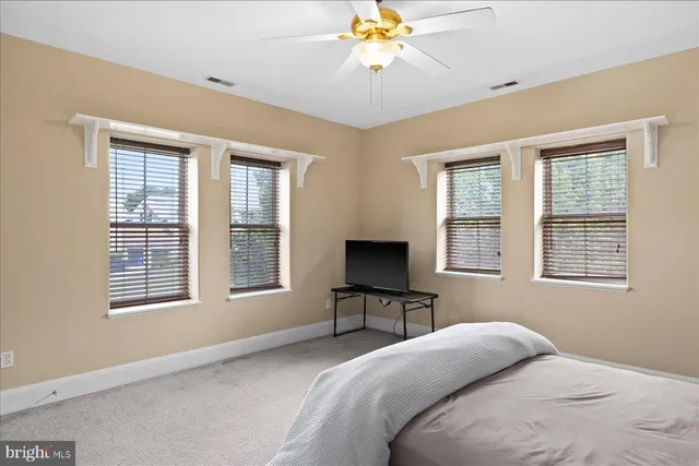 a spacious bathroom with a granite countertop sink a mirror and a shower