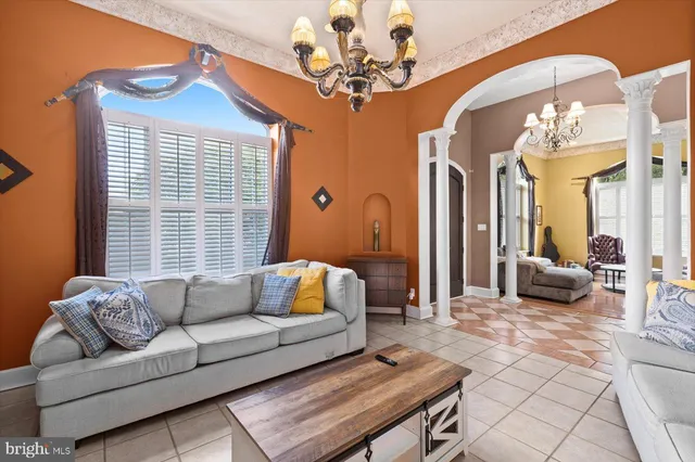 a living room with furniture and a chandelier