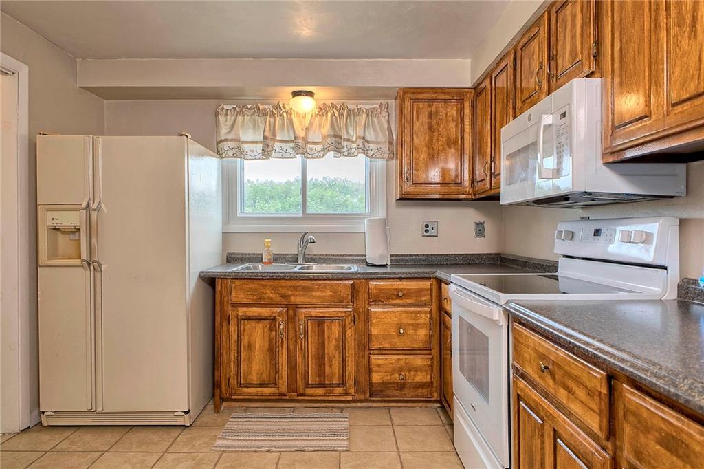8002 Hayward Street Irwin, PA 15642 - Photo 13 of 31 a kitchen with stainless steel appliances granite countertop a refrigerator and a sink