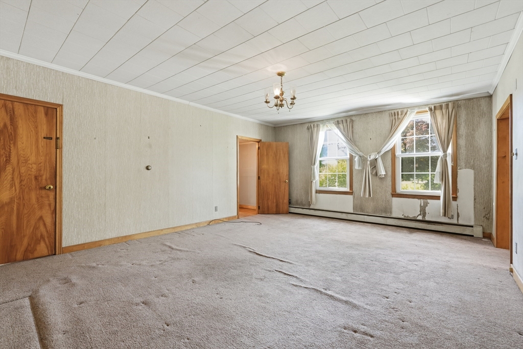 15 Main Street Hatfield, MA 01038 - Photo 8 of 42 an empty room with chandelier fan and windows