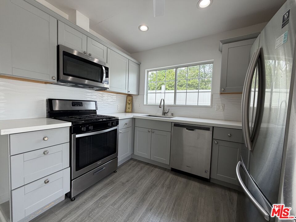18601 Hiawatha Street Porter Ranch, CA 91326 - Photo 12 of 22 a kitchen with a sink stove and microwave