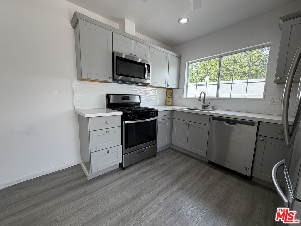 18601 Hiawatha Street Porter Ranch, CA 91326 - Photo 14 of 22 a kitchen with a sink appliances and cabinets