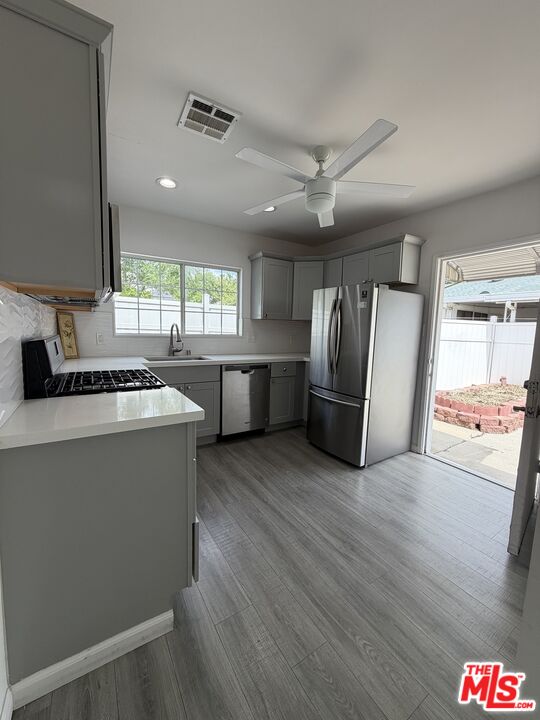 18601 Hiawatha Street Porter Ranch, CA 91326 - Photo 15 of 22 a kitchen with stainless steel appliances granite countertop a refrigerator and a sink