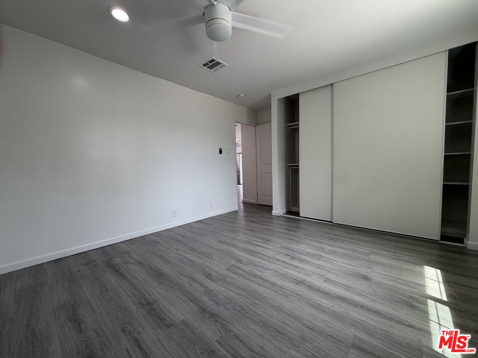 18601 Hiawatha Street Porter Ranch, CA 91326 - Photo 7 of 22 an empty room with wooden floor and windows