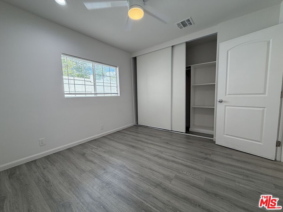 18601 Hiawatha Street Porter Ranch, CA 91326 - Photo 10 of 22 an empty room with wooden floor and windows