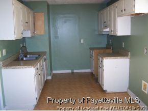 206 Duncan Road Spring Lake, NC 28390 - Photo 3 of 5 a kitchen with a sink a stove and cabinets
