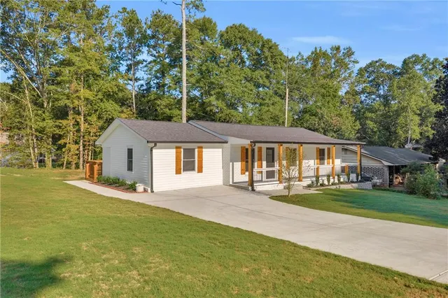 a front view of a house with a garden