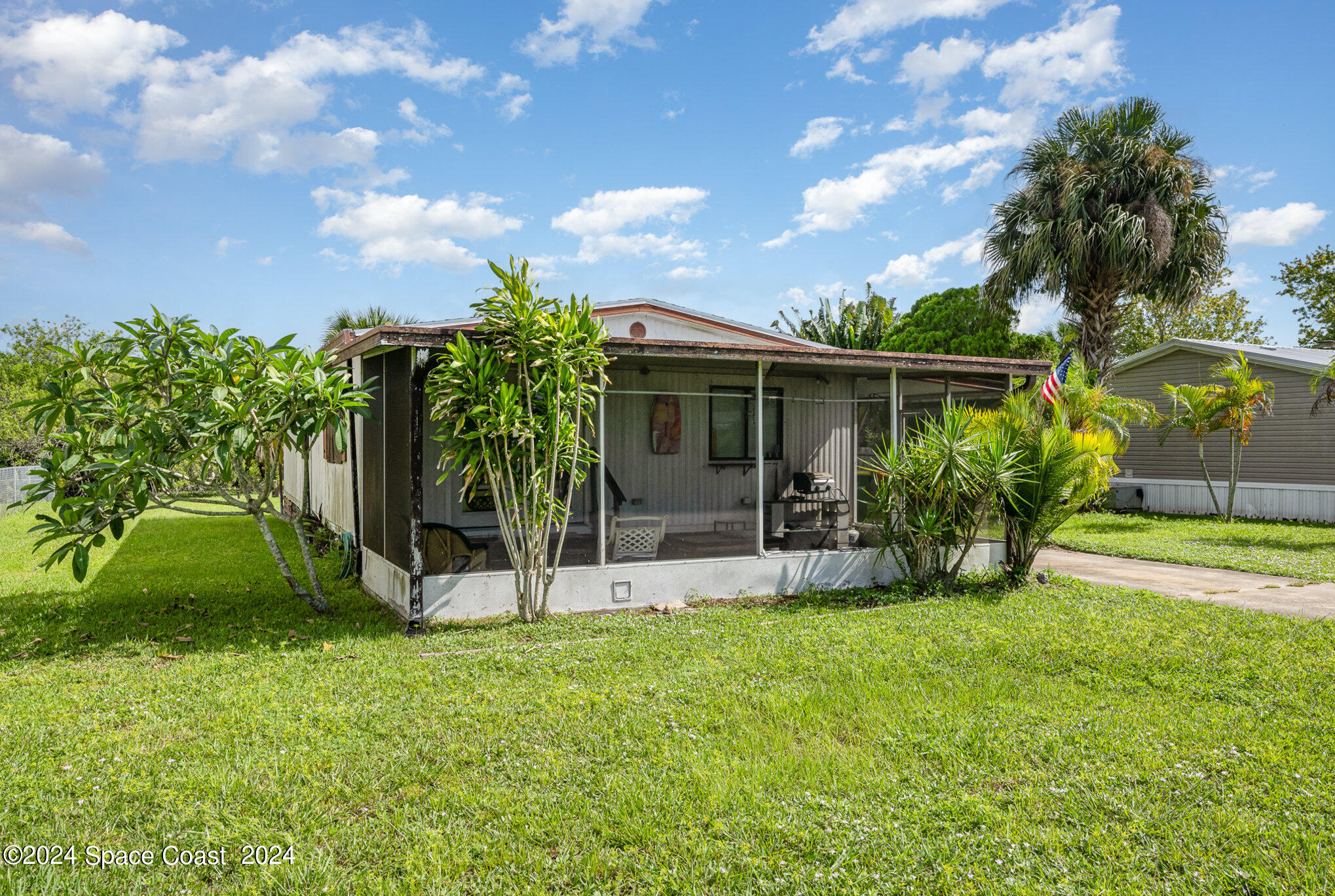 420 Baker Road Merritt Island, FL 32953 - Photo 3 of 22 a view of backyard with a garden and plants