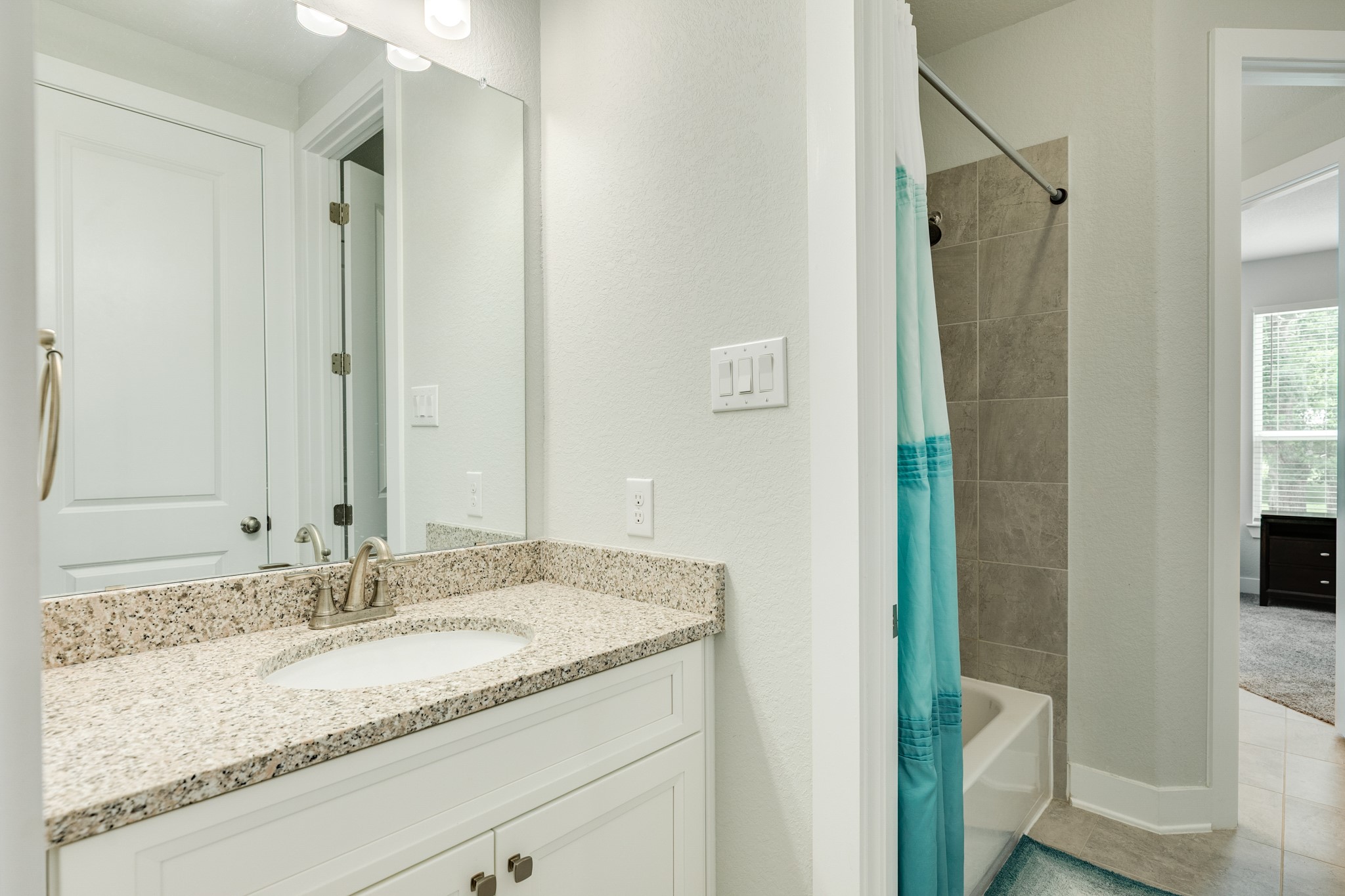 527 Lakeland Circle Rosharon, TX 77583 - Photo 36 of 42 a bathroom with a granite countertop sink and a mirror