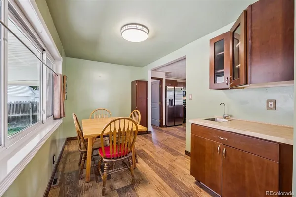 a view of a dining room with furniture window and wooden floor
