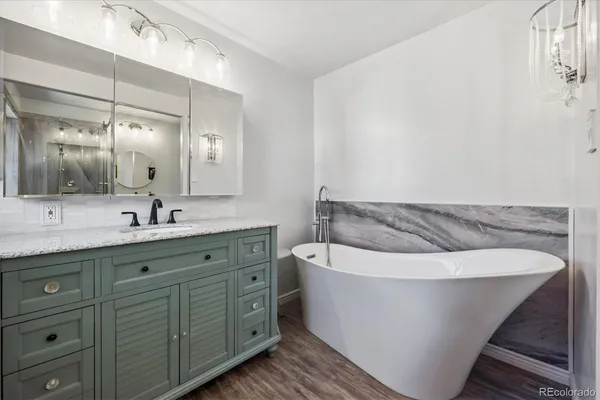 a spacious bathroom with a double vanity sink mirror and bathtub