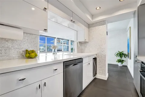 a kitchen with sink and cabinets