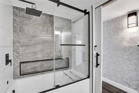 a bathroom with a glass shower door