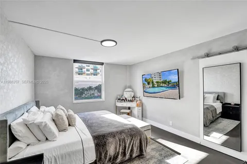 a bedroom with a bed and glass windows