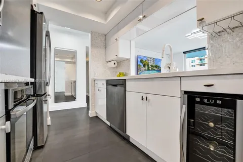 a kitchen with a refrigerator and a stove