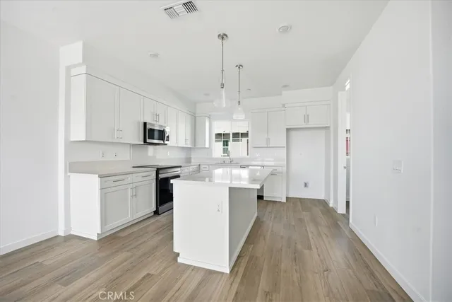 a kitchen with a sink stove and microwave