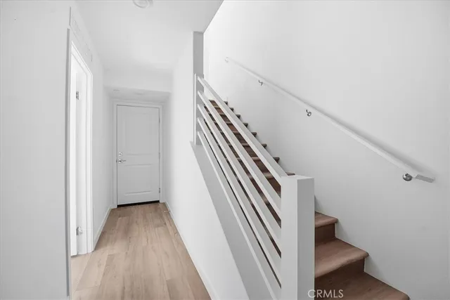 a bedroom with a bed and a view of kitchen