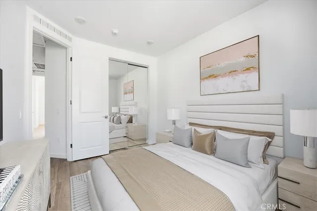 a bedroom with a bed and a flat screen tv