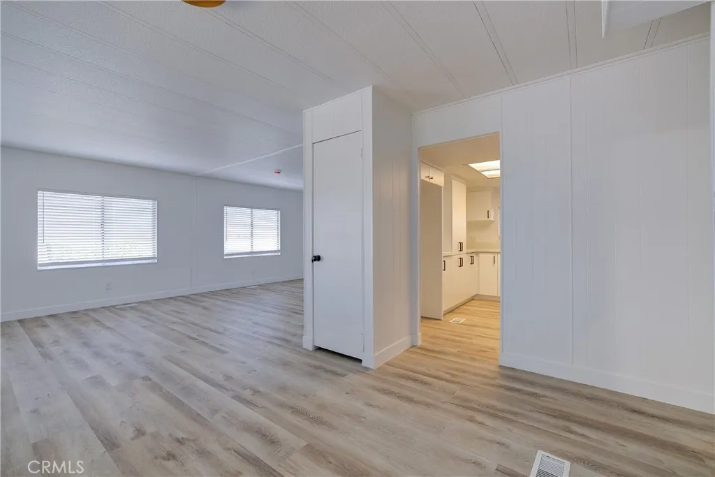 3700 Buchanan Street, Unit 164 Riverside, CA 92503 - Photo 9 of 40 an empty room with wooden floor and windows