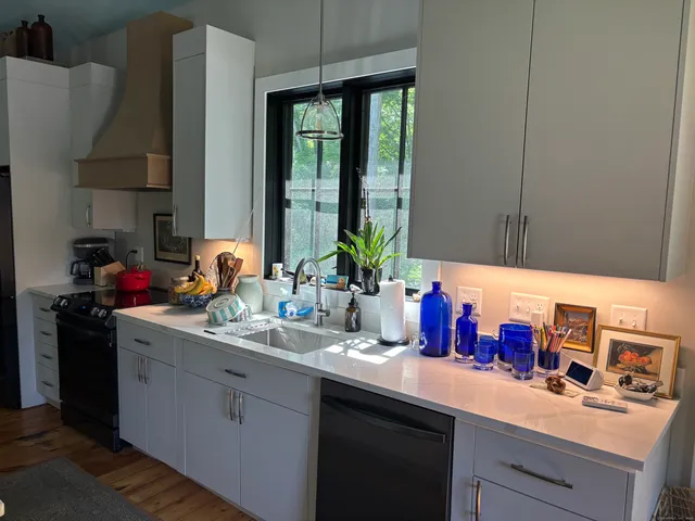 a kitchen with sink and cabinets