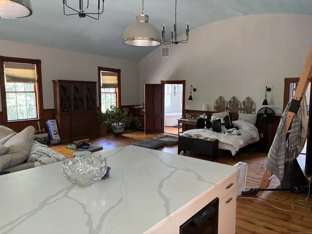 a bedroom with furniture and a wooden floor