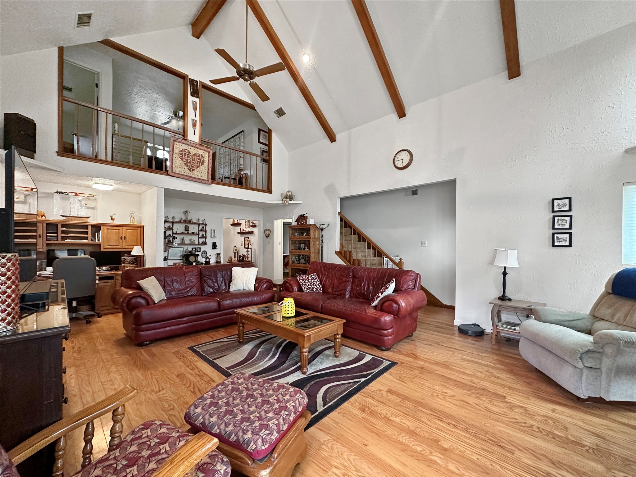 17423 Fairway Oaks Drive Spring, TX 77379 - Photo 7 of 50 LOFT LIVING SPACE, DESIGNATED WORKSPACE WITH BUILT IN DESK AND SHELVING, CATHEDRAL CEILING, EXPOSED BEAMS, NATURAL LIGHTING AND 2 EXITS TO THE BACKYARD. ONLY CARPET IN HOME IS ON THE STAIRS.