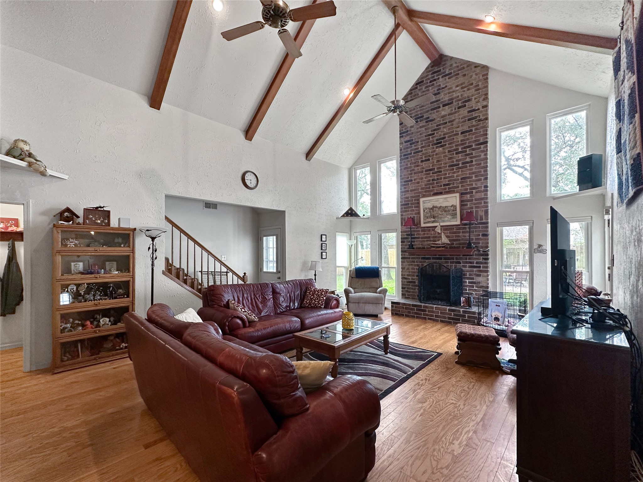 17423 Fairway Oaks Drive Spring, TX 77379 - Photo 8 of 50 a living room with furniture a fireplace and a flat screen tv