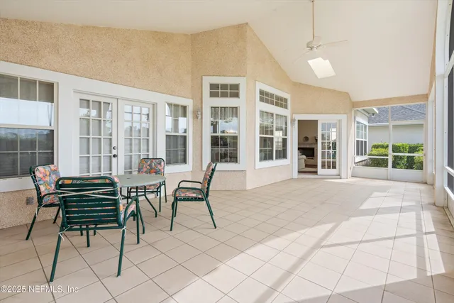 a view of a house with backyard and sitting area