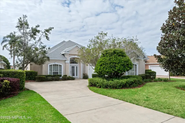 a front view of a house with a garden