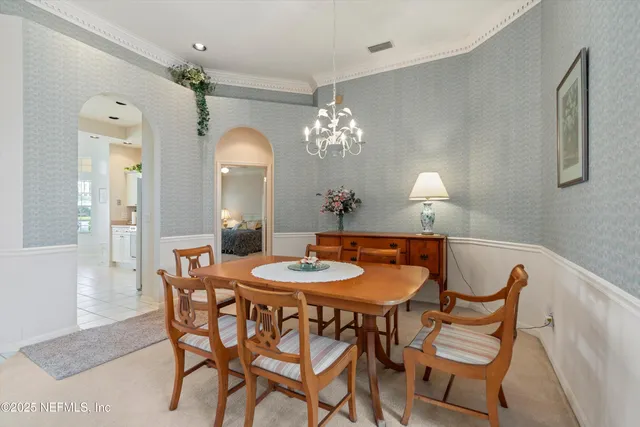 a dining room with furniture and chandelier