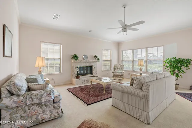a living room with furniture fireplace and a large window