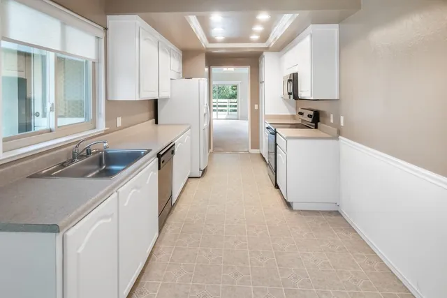 a kitchen with a sink stove and refrigerator