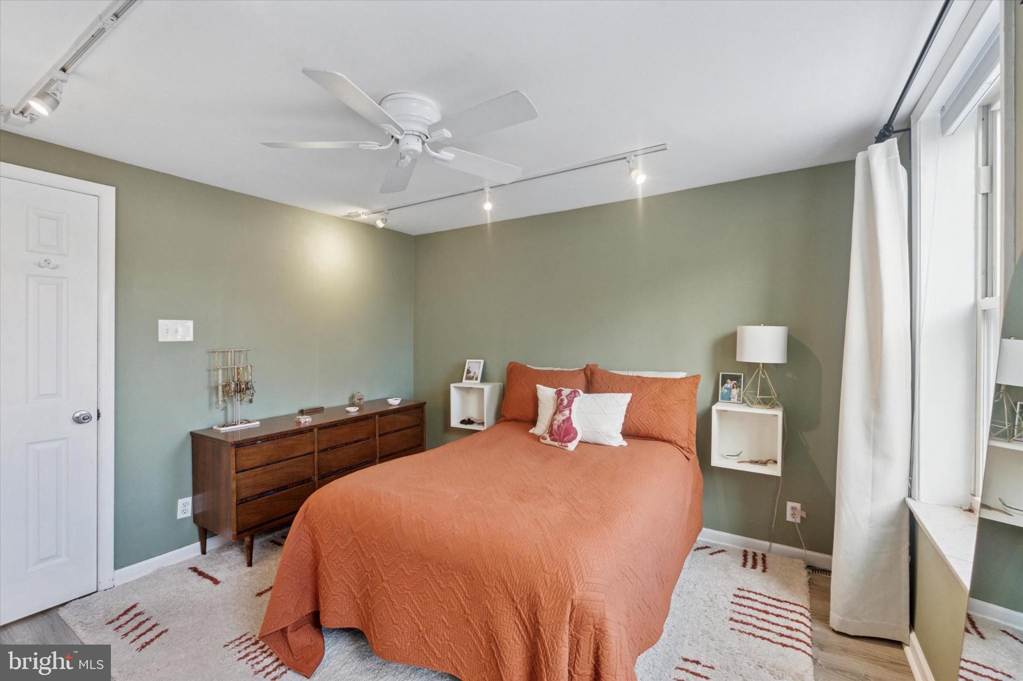 804 Sears Street Philadelphia, PA 19147 - Photo 12 of 25 a bedroom with a bed and a chandelier