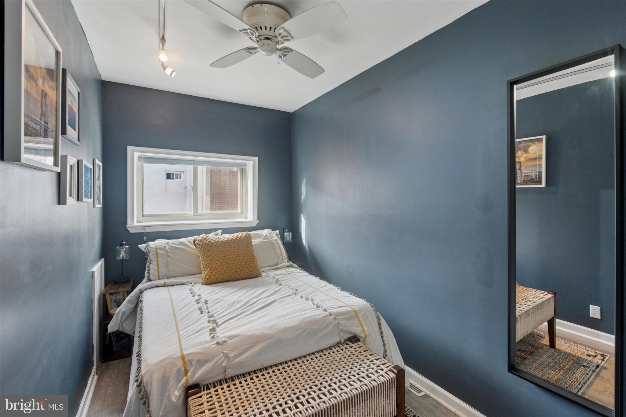 804 Sears Street Philadelphia, PA 19147 - Photo 15 of 25 a bedroom with a large bed and a chandelier