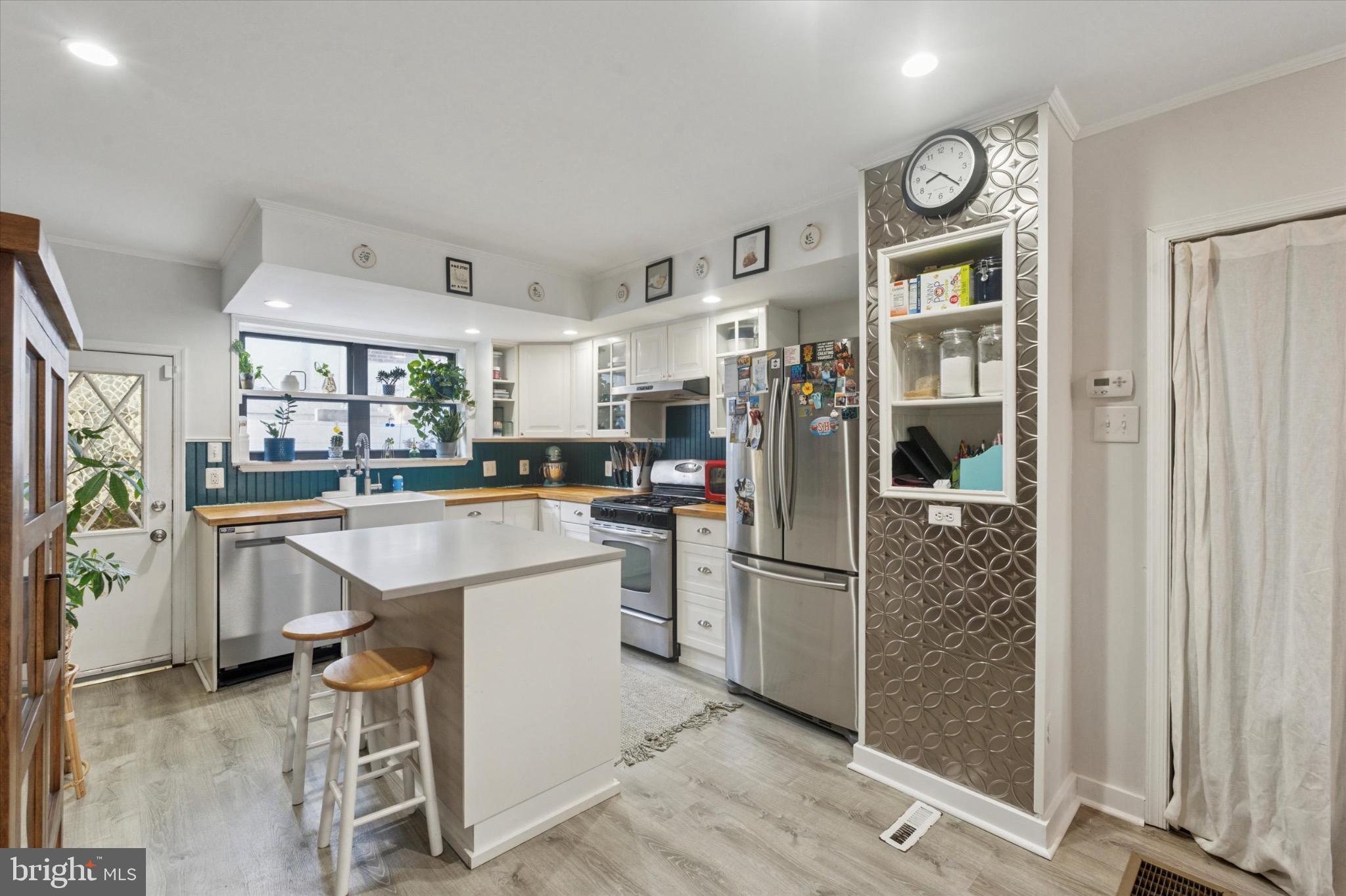 804 Sears Street Philadelphia, PA 19147 - Photo 7 of 25 a kitchen with white cabinets and stainless steel appliances
