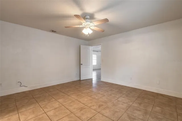 a bathroom with a granite countertop sink a toilet and a mirror