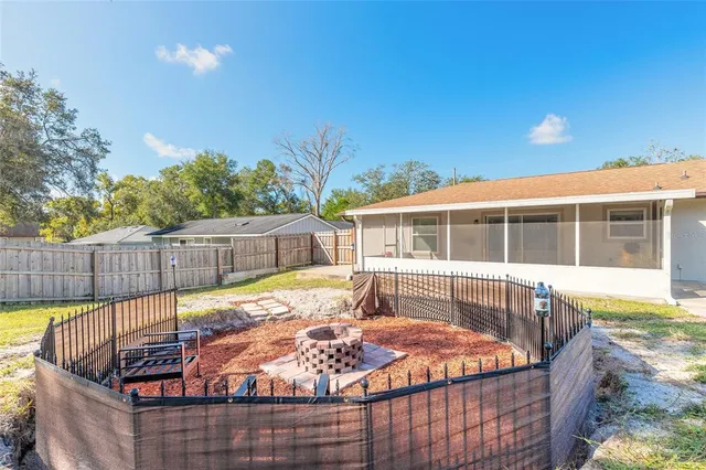 a swimming pool with yard in front of it