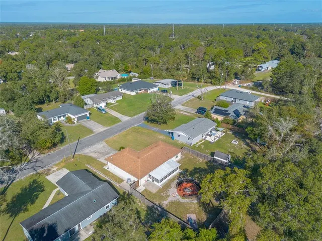 an aerial view of a house with outdoor space