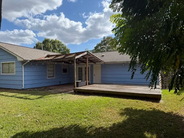 a view of a backyard with a large tree