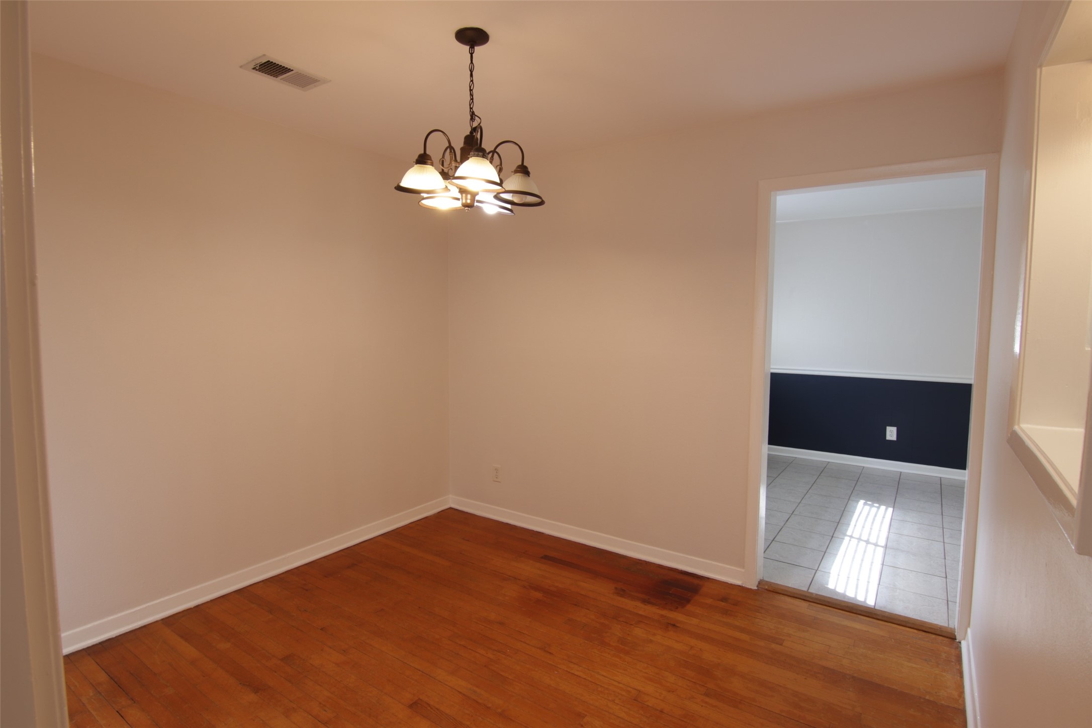 7030 Sharpview Drive Houston, TX 77074 - Photo 2 of 20 a view of empty room with wooden floor