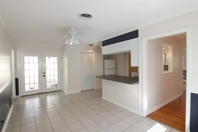 a view of an empty room with window and cabinet