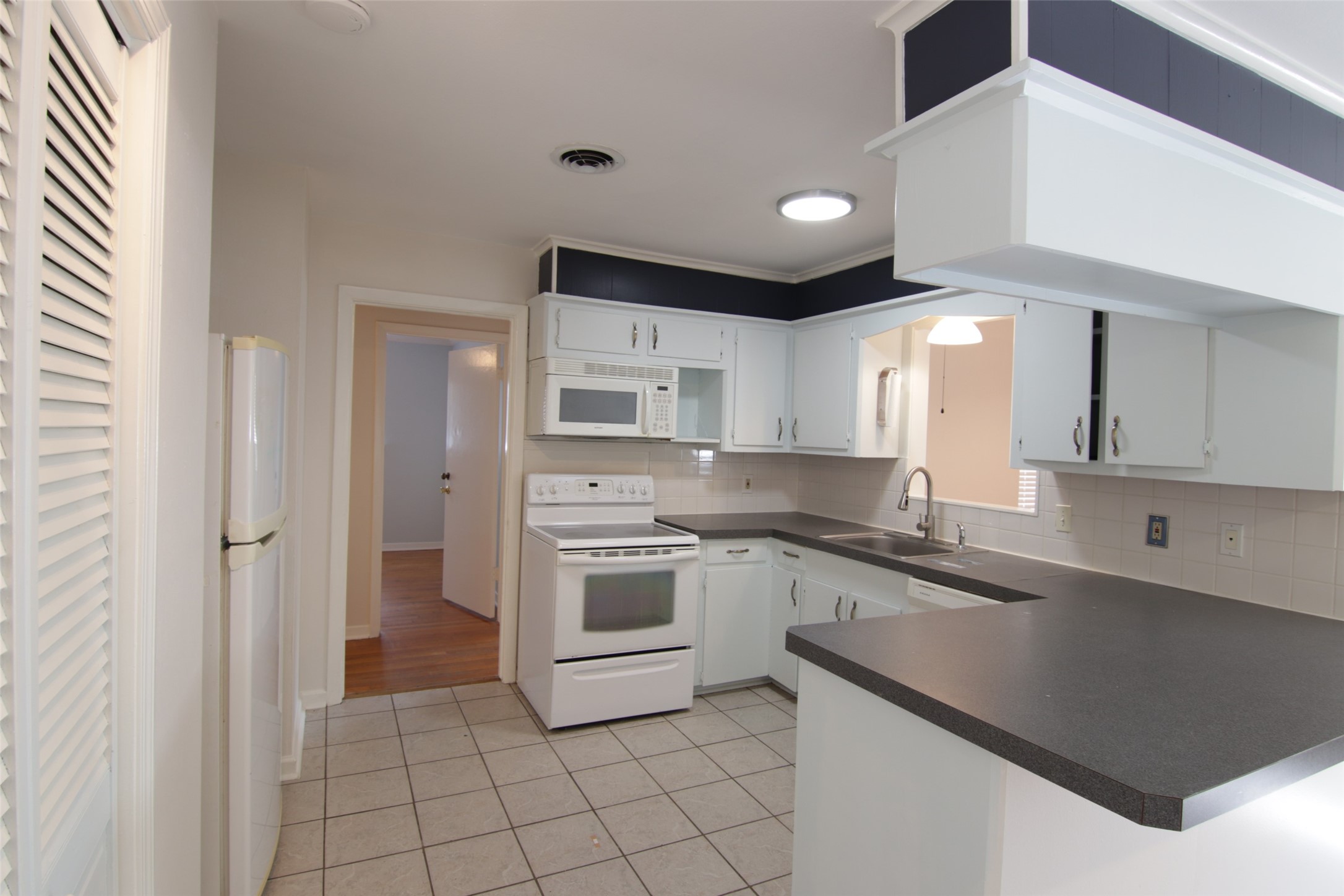7030 Sharpview Drive Houston, TX 77074 - Photo 10 of 20 a kitchen with stainless steel appliances granite countertop a sink and cabinets