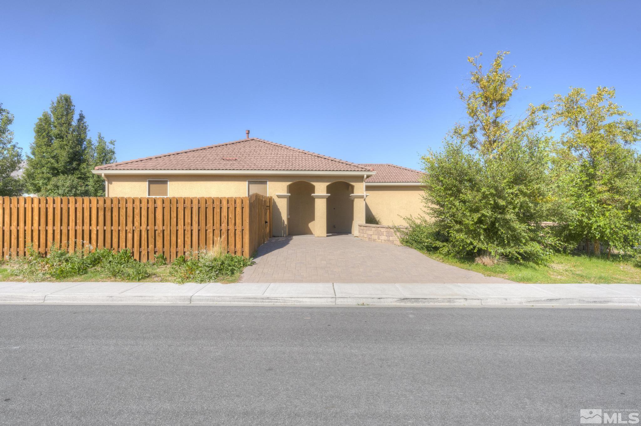 490 Pesaro Way Reno, NV 89521 - Photo 3 of 28 a front view of a house with a yard and garage