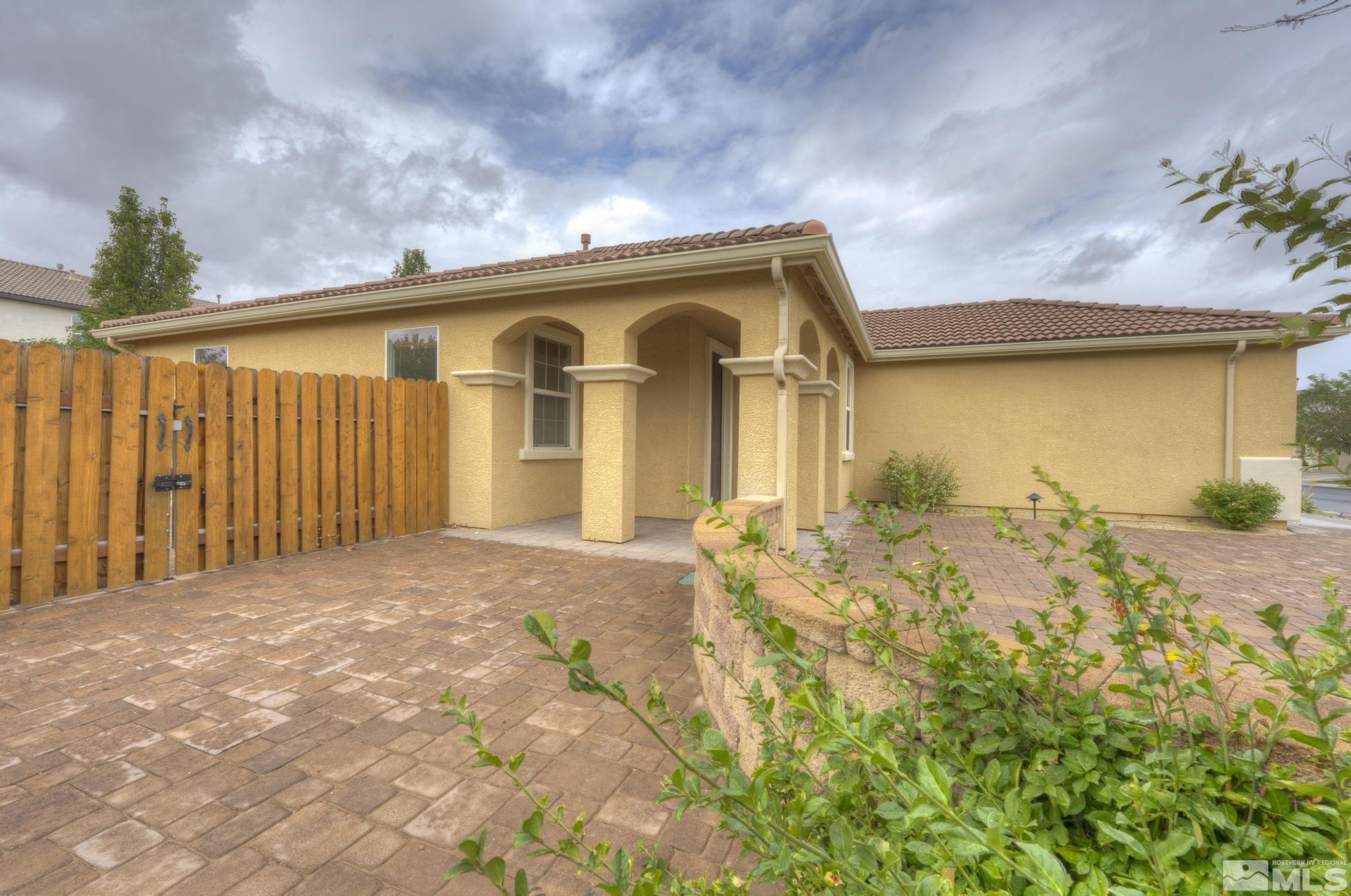 490 Pesaro Way Reno, NV 89521 - Photo 6 of 28 a front view of a house with a yard