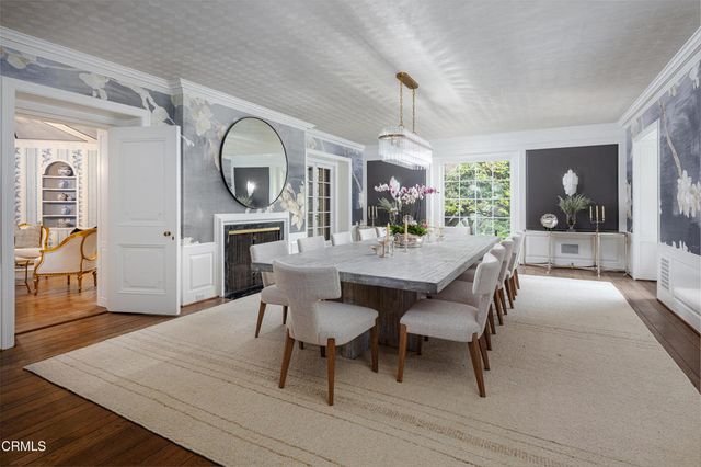 a kitchen with stainless steel appliances granite countertop a kitchen island a stove and a sink