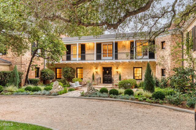 a living room with furniture a fireplace and a chandelier