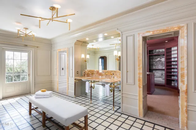 a view of a dining room with furniture and a chandelier