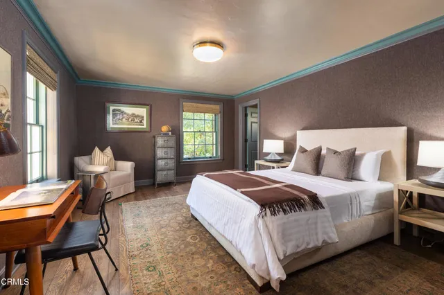 a bedroom with a bed and a large window