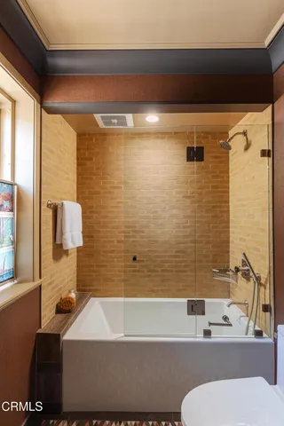 a bathroom with a tub and a shower