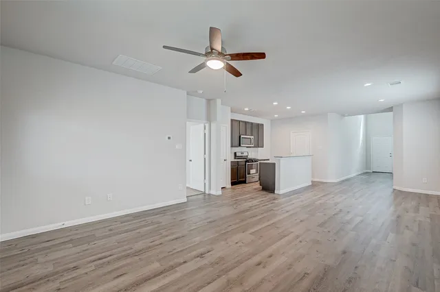 a view of a kitchen with a sink and wooden floor